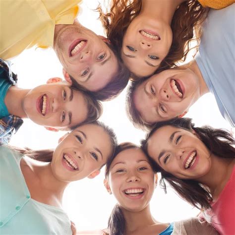 Group of smiling teenagers Stock Photo by ©Syda_Productions 62812007