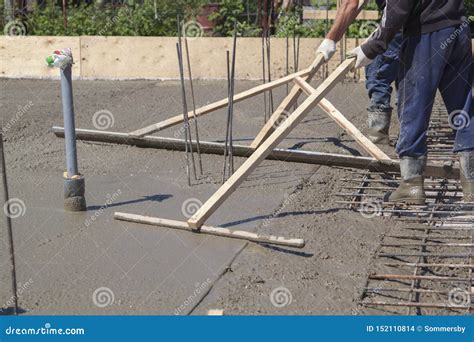 Workers Leveling Fresh Concrete Slab with a Special Working Tool Stock ...