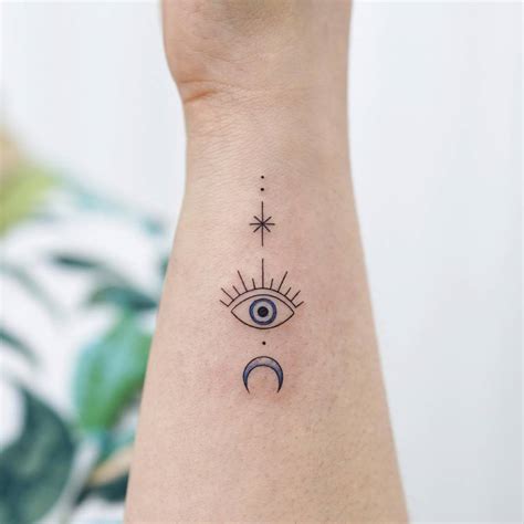 Evil eye tattoo located on the wrist, minimalistic