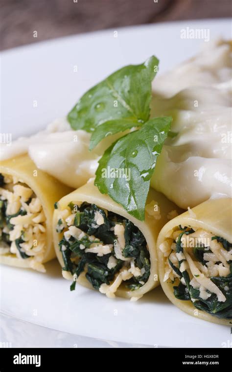 Italian pasta cannelloni stuffed with spinach and cheese with bechamel ...