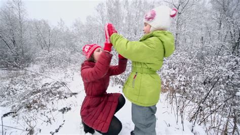 Little Girl With Her Mother Play Pat-a-cake Game In Winter Park, (shown ...