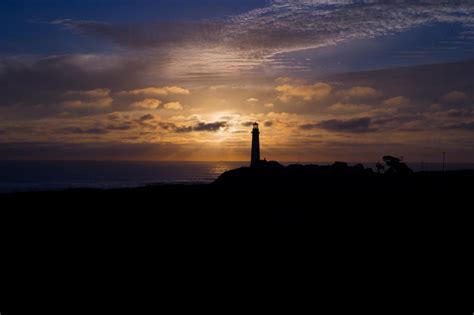 Lighthouse Silhouette at Sunset free image download