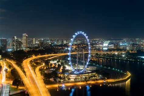 Premium Photo | Aerial view of singapore flyer and city at night in ...