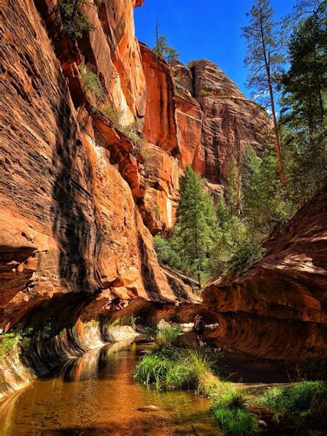 a river running through a canyon surrounded by tall rocks