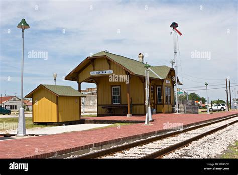 Small town railroad passenger train station with tracks, semaphore ...