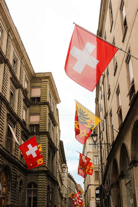 Swiss flag on buildings in narrow alley · Free Stock Photo