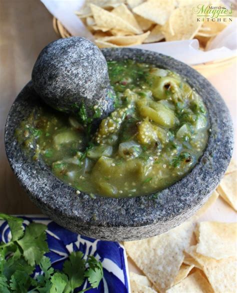 Molcajete Salsa Verde surrounded by corn tortilla chips and green ...