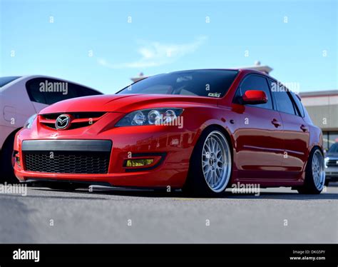 Heavily lowered Mazda 3 car, modified on large alloy wheels Stock Photo ...