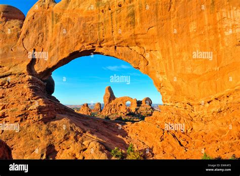 sunrise over Double Arch as it frames Turret Arch, Arches National park ...