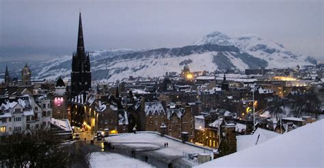 A snowy Royal Mile & Arthur's Seat from Edinburgh Castle, the prominent ...