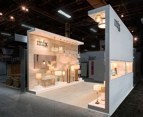 a trade show booth with lights and furniture on the floor in front of ...