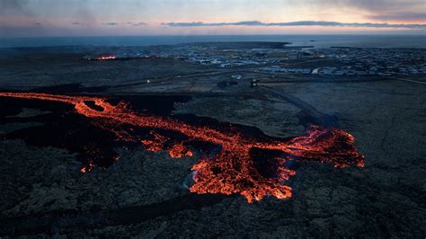 Drone footage Iceland volcano in Grindavik lava surrounding houses ...