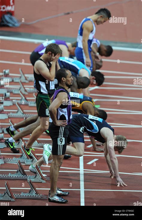 Sprinters in the starting blocks on a running track Stock Photo - Alamy