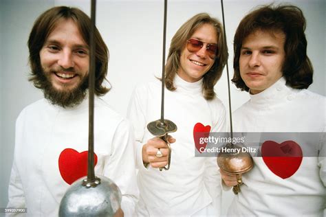 America band members Dewey Bunnell, Gerry Beckley, and Dan Peek stand ...