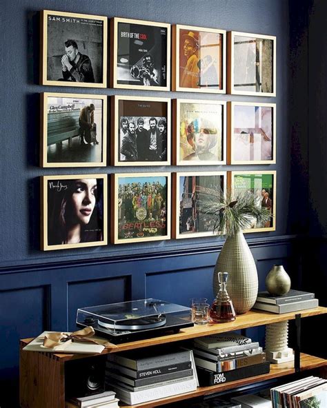 a blue room with pictures on the wall and a vase in front of it that ...