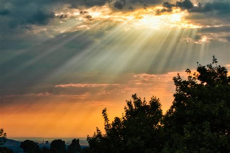 Rays of light shining through the clouds on a hazy summer day. : r/pics