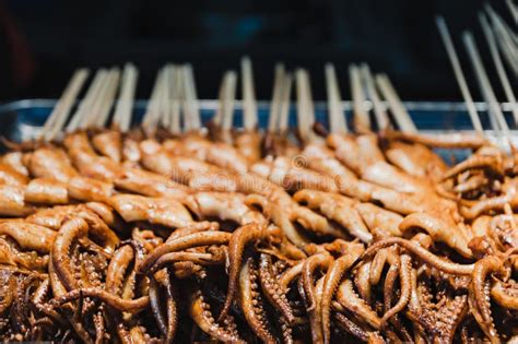 Chinese Street Food. Fried Octopus on Stick Stock Photo - Image of ...