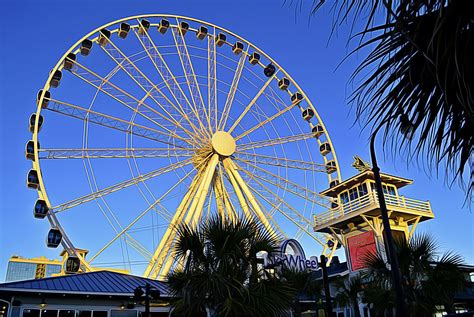 Standing at the entrance of the Myrtle Beach SkyWheel at sunset ...