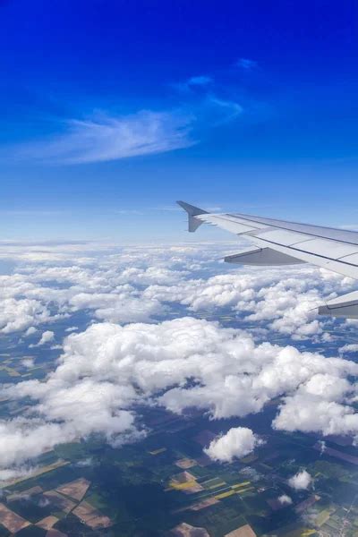 Plane view from the window on picturesque white clouds - Stock Image ...