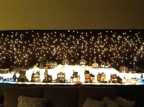 My Christmas village Backdrop is icicle lights hung on the wall with ...