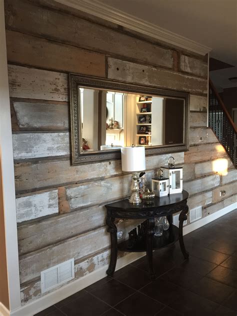 a living room with wood paneling on the wall and a table in front of it