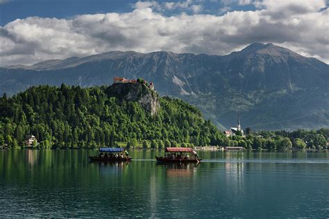 Traditional Pletna boats with colorful canopy on Lake Bled with ...