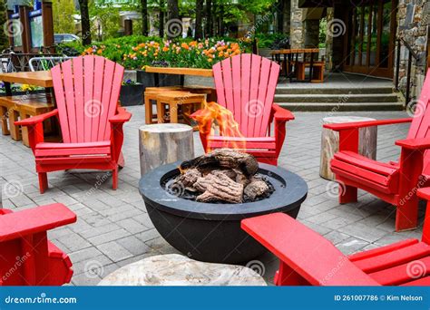 Bright Red Adirondack Chairs Around a Gas Fire Pit, Seating in an ...