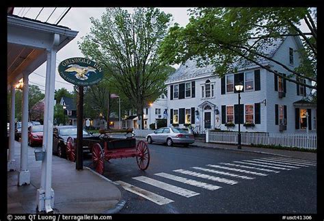 Essex. Connecticut, USA. Street with historic buildings at dusk ...