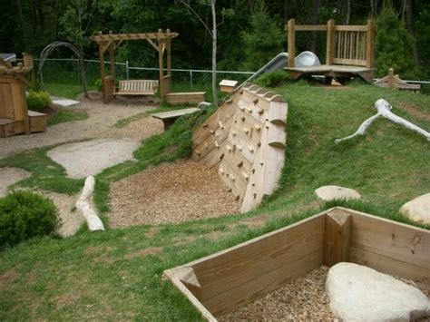 rock wall and slide on a hill | Backyard playground, Natural playground ...