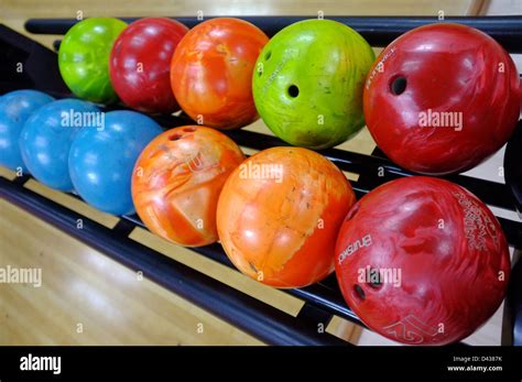 A tray of bowling balls of different weights and colours at a bowling ...