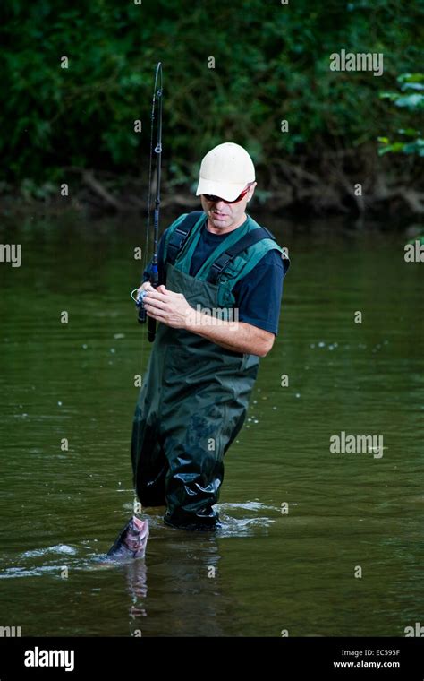 a angler fishing in the river Stock Photo - Alamy