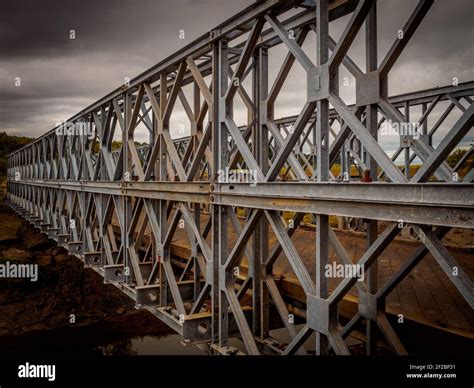 Splendid and typical iron girder bridge with a wooden platform near ...