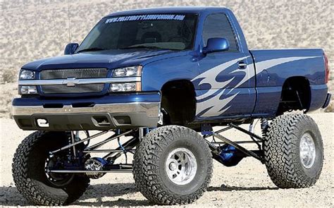 a blue truck is parked in the desert