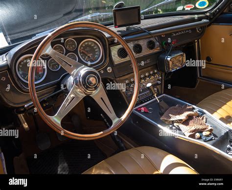 Interior of a classic Maserati Sebring sports car with driving gloves ...