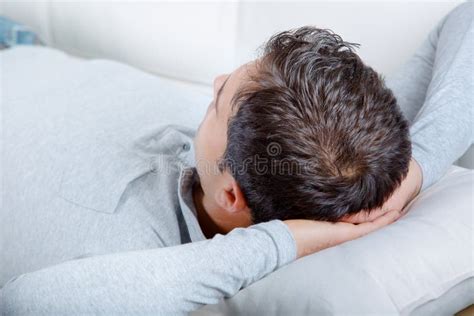 Man resting on couch stock image. Image of apartment - 101666467