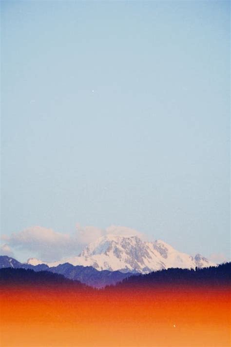 A photo of a mountain range with a red sky · Free Stock Photo