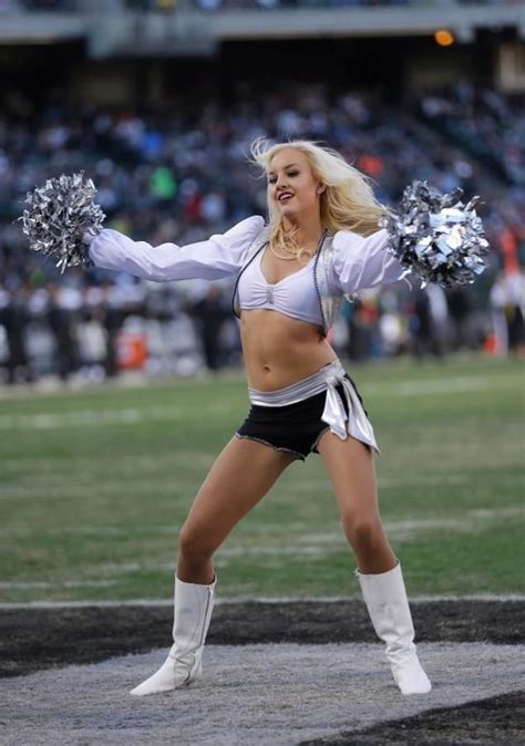 a cheerleader is performing on the field at a football game