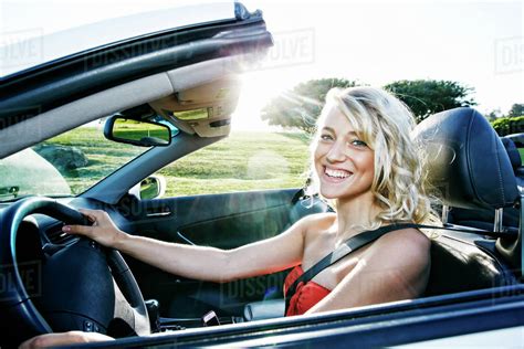 Caucasian woman driving convertible - Stock Photo - Dissolve