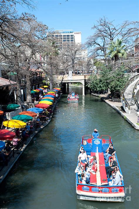 Tourist taking a tour boat ride along the famous riverwalk in downtown ...