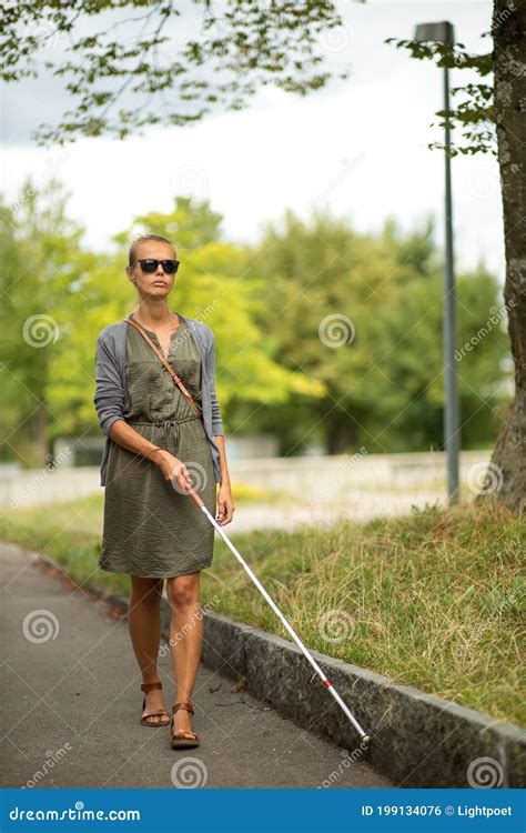 Blind Woman Walking on City Streets, Using Her White Cane Stock Photo ...