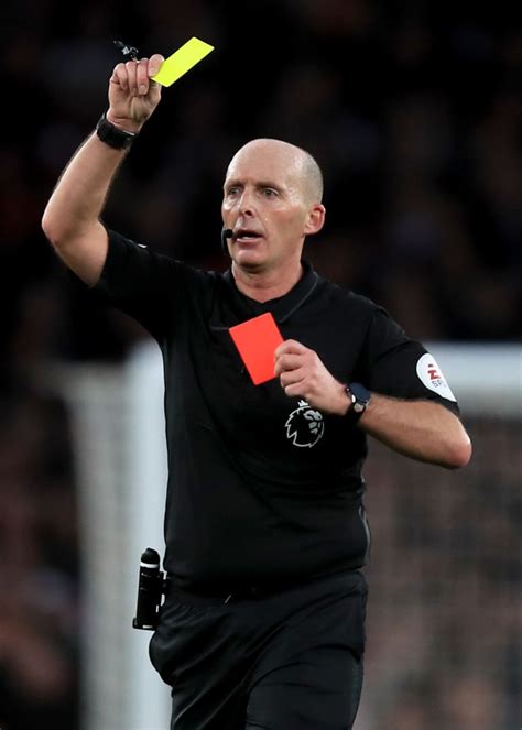 Referee Mike Dean shows a 2nd yellow followed by a red card during ...