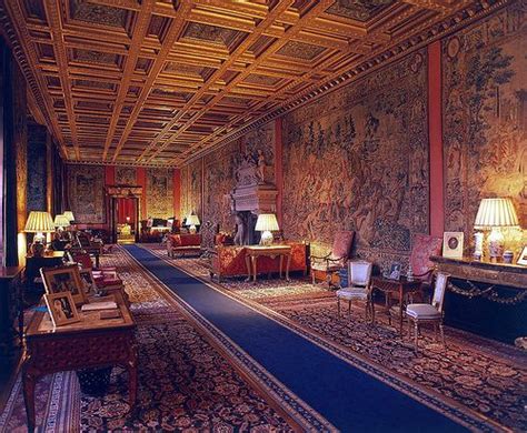 an ornately decorated room with couches, lamps and tapestryed wallpapers