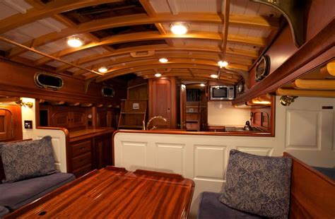 the interior of a boat with wooden furniture and wood flooring ...