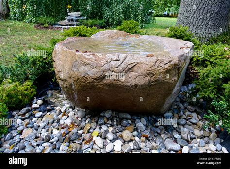 Stone fountain in a garden Stock Photo - Alamy