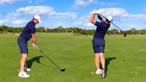 two men are playing golf on the green with their backs turned to the ...