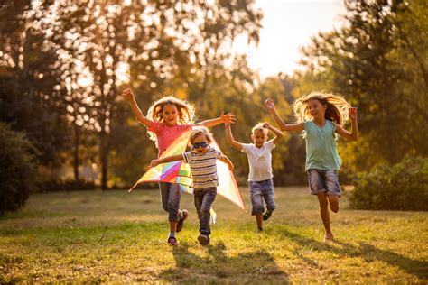 Group of happy children running in public park - Review of Myopia ...