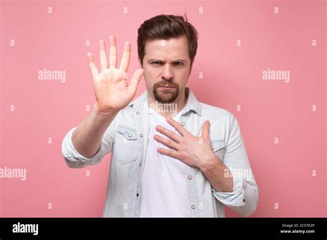 man holding out his hand to show stop gesture Stock Photo - Alamy