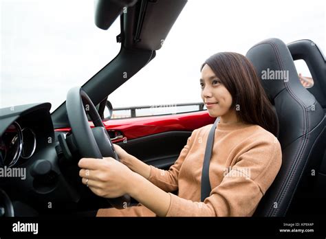 Woman driving convertible car Stock Photo - Alamy