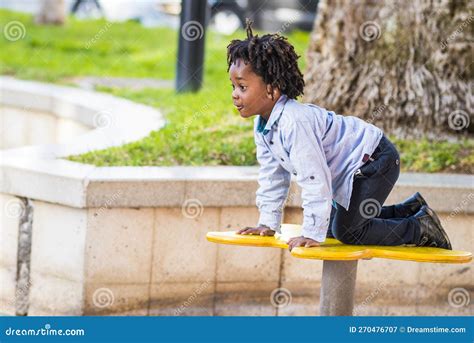 One Young Black Children Enjoy Time Having Fun at the Playground in ...