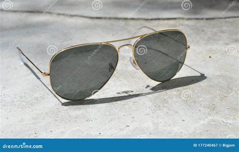 Gold Frame Aviator Black Sunglasses on Floor Stock Image - Image of ...